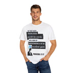 Man wearing a white t-shirt with Proverbs 17:27 text design on a white background
