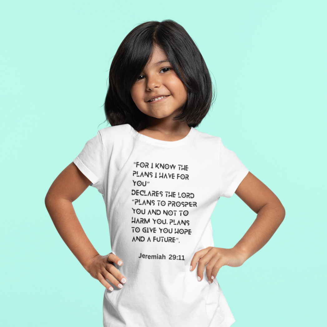 Child wearing a white t-shirt with text on a light blue background