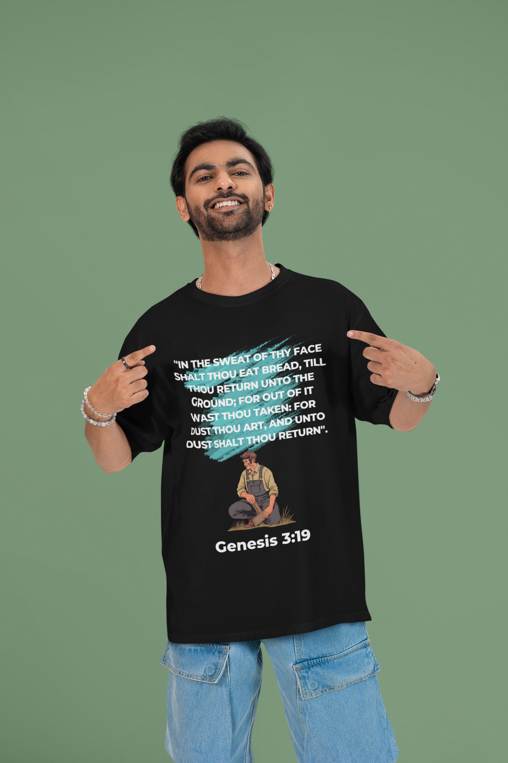 Man wearing a black t-shirt with text and a graphic, standing against a green background