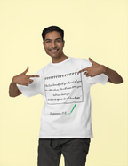 Man wearing a white t-shirt with text and pointing to it, on a beige background