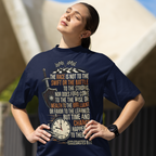 Woman wearing a navy blue t-shirt with text and graphics, standing outdoors.