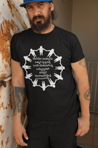Man wearing a black t-shirt with a white graphic design, standing against a wall.