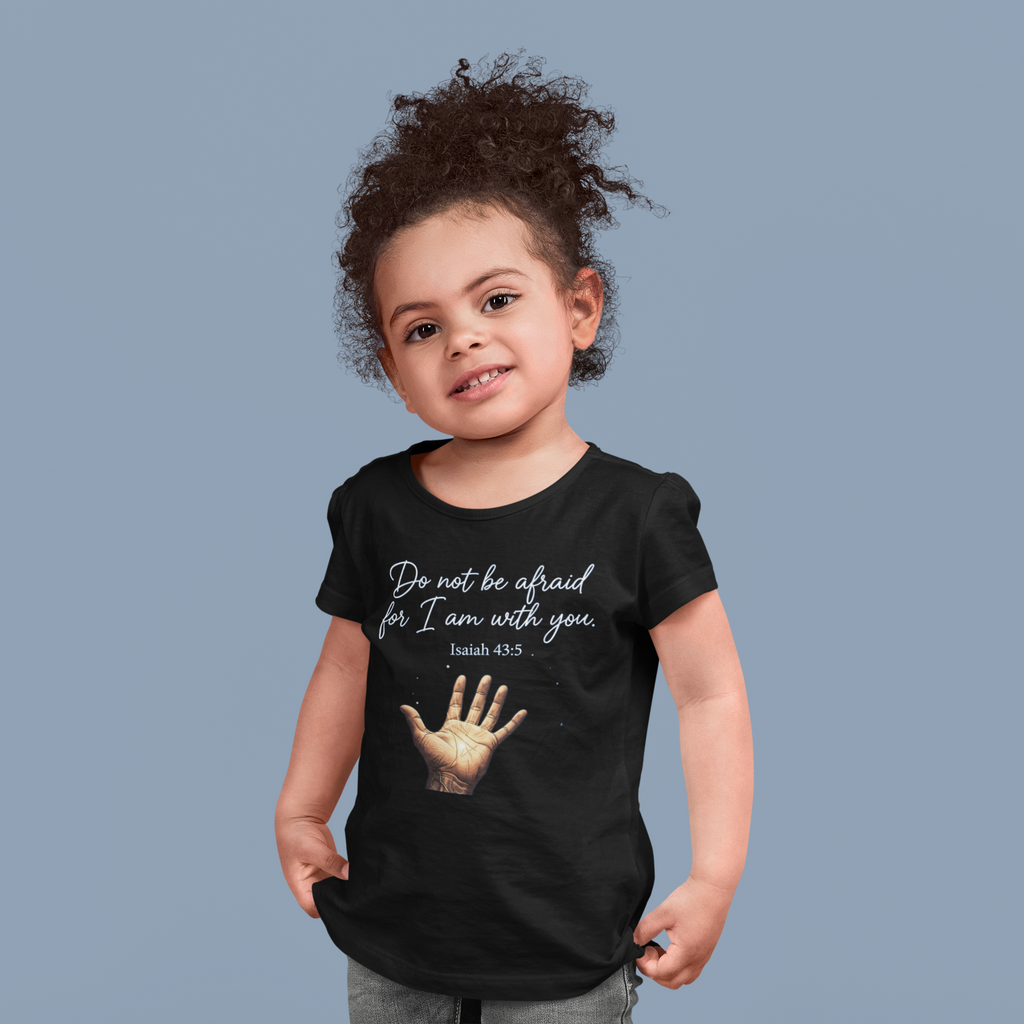Child wearing a black t-shirt with a motivational quote and hand graphic on a solid background